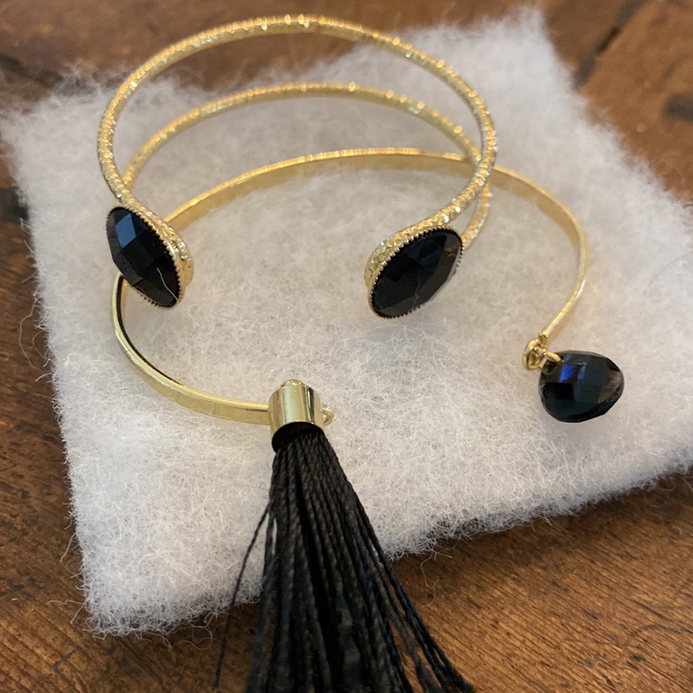 Pretty gold tone, bracelets with black stones.